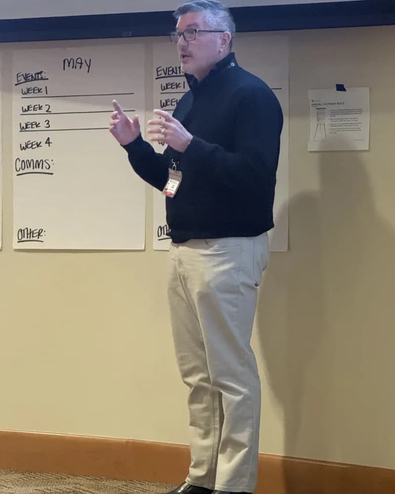 Allen Abbott leading an annual calendar planning session in front of a hand-built wall calendar