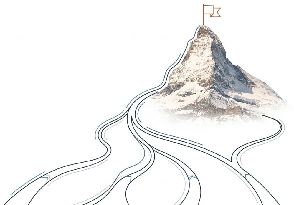 Mountain with trails converging toward a summit flag.